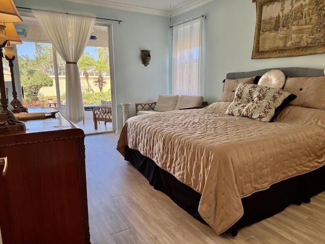bedroom with access to outside, crown molding, and wood finished floors