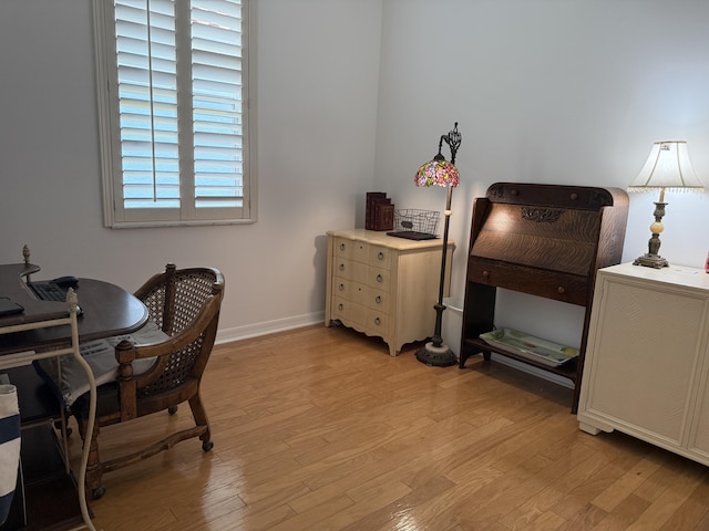 office area with light wood-style flooring and baseboards