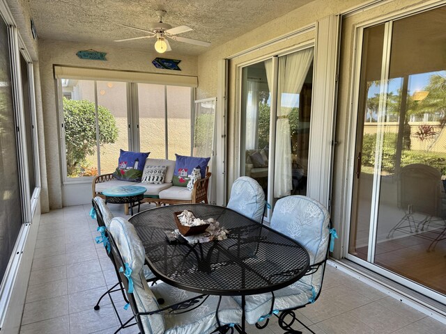 sunroom / solarium with a ceiling fan