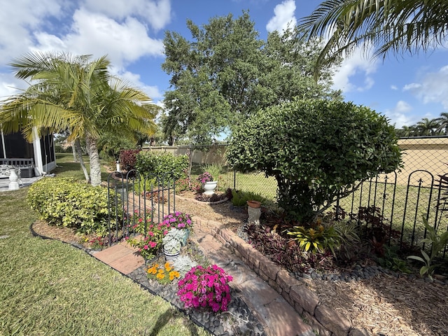 view of yard with fence and a sunroom