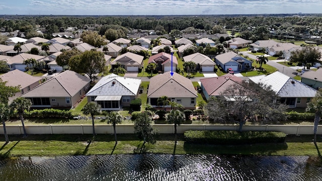 birds eye view of property with a water view and a residential view
