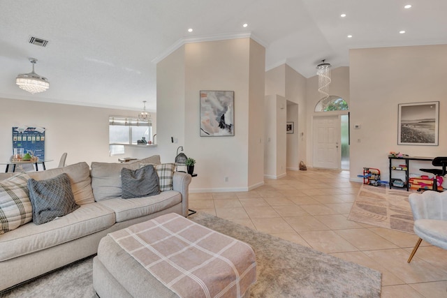 living area with visible vents, crown molding, baseboards, and light tile patterned floors