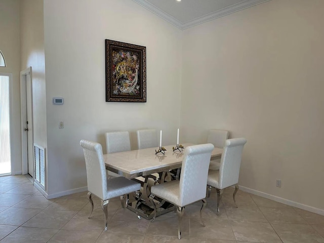 dining area featuring light tile patterned floors, ornamental molding, visible vents, and baseboards