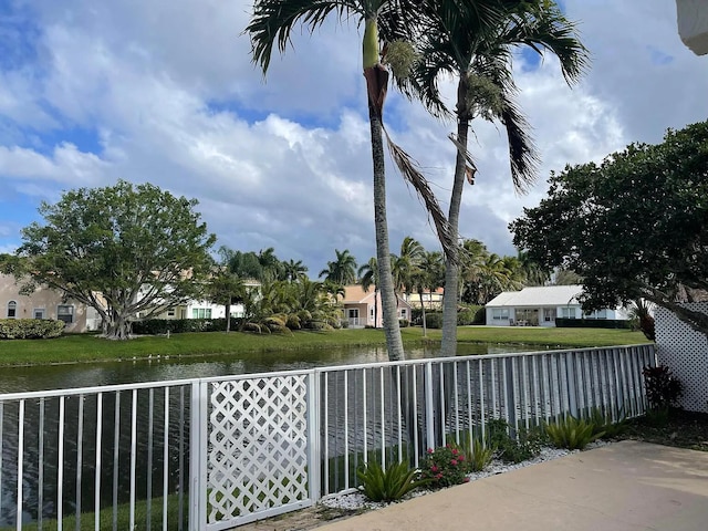 exterior space featuring a water view and fence