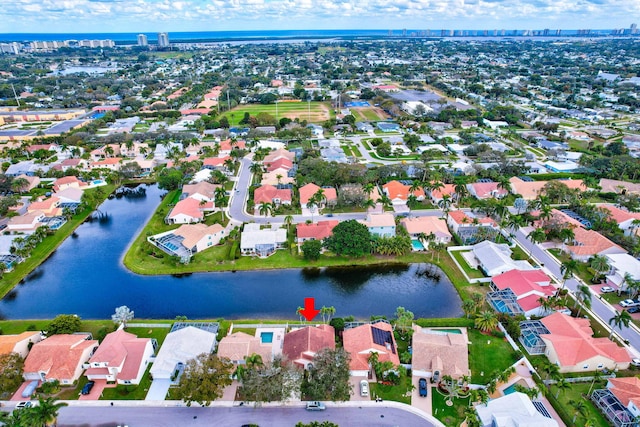 birds eye view of property with a water view and a residential view