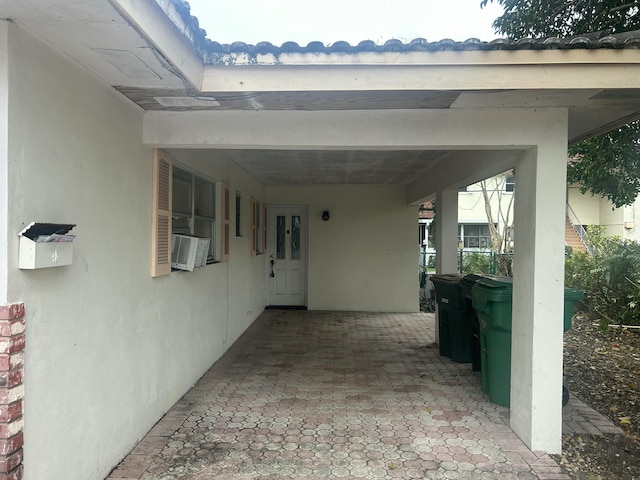 view of patio / terrace featuring cooling unit and a carport