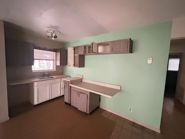 kitchen with sink and dark tile patterned flooring