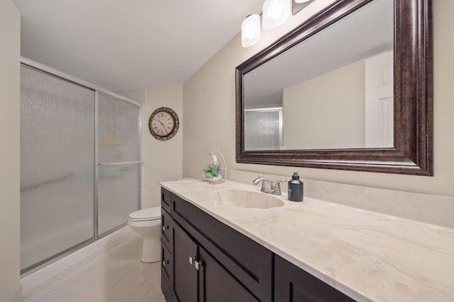 bathroom featuring walk in shower, vanity, toilet, and tile patterned flooring