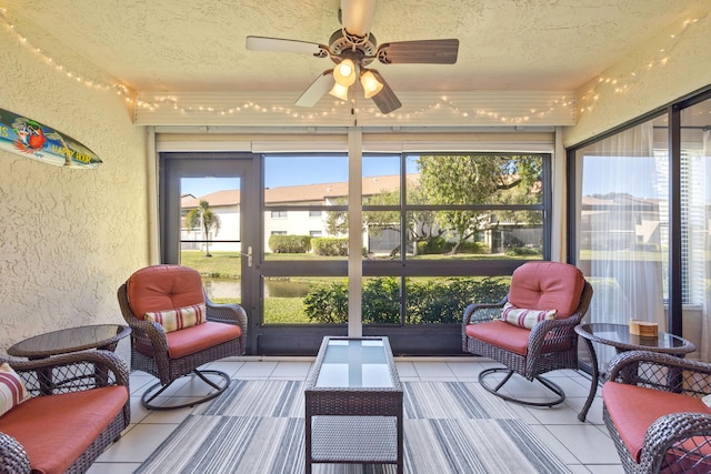 sunroom / solarium featuring ceiling fan