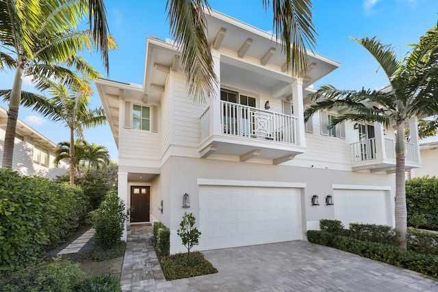 view of front of home with a garage and a balcony