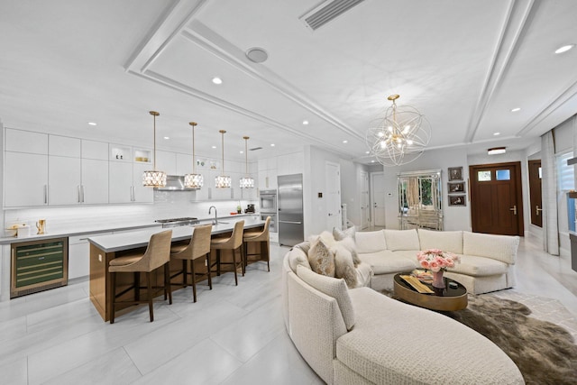 living room with indoor bar, wine cooler, and an inviting chandelier