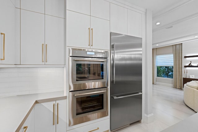 kitchen with stainless steel appliances and white cabinets