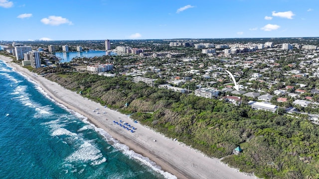 birds eye view of property featuring a water view and a beach view