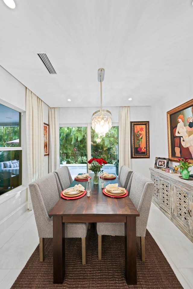 dining room with an inviting chandelier and light tile patterned floors