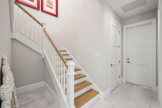 stairs featuring tile patterned flooring