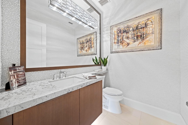 bathroom with crown molding, vanity, toilet, and tile patterned flooring