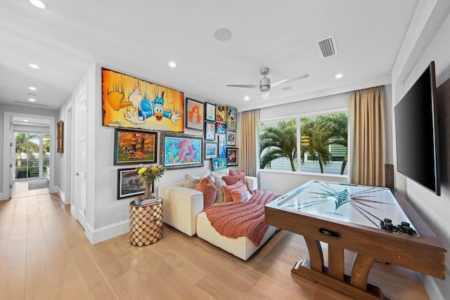 recreation room featuring ceiling fan and light wood-type flooring