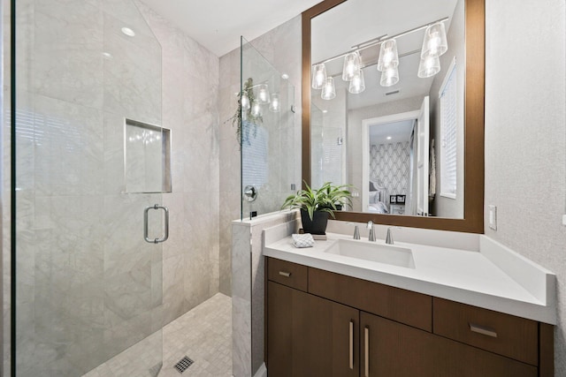 bathroom featuring vanity and a shower with door