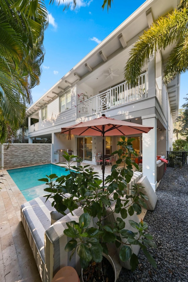 view of swimming pool with ceiling fan, a hot tub, and a patio area