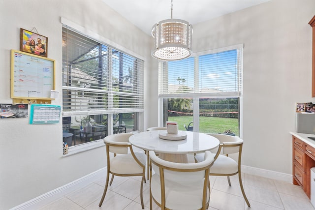 dining space featuring light tile patterned flooring and a chandelier