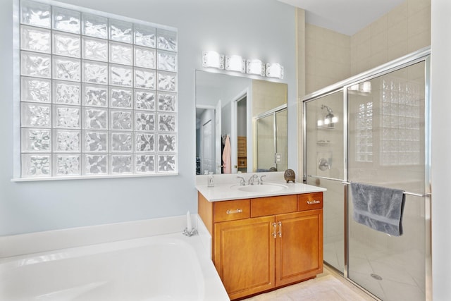 bathroom featuring vanity and separate shower and tub