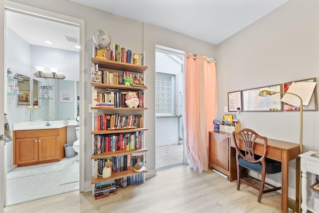 office space featuring sink and light hardwood / wood-style floors