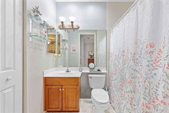 bathroom with vanity, curtained shower, and toilet