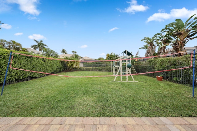 view of home's community featuring a playground, a lawn, and volleyball court