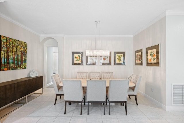 dining area with light tile patterned floors and ornamental molding