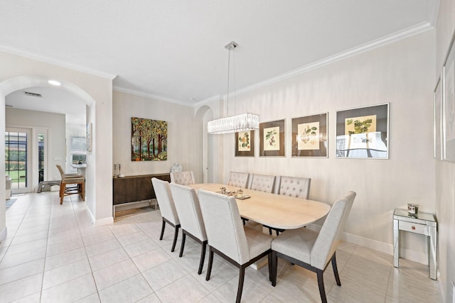 dining space with light tile patterned flooring, ornamental molding, and an inviting chandelier