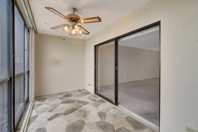 unfurnished sunroom with ceiling fan