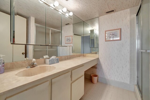 bathroom featuring a stall shower, visible vents, and vanity