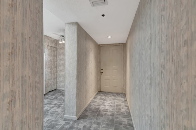 hallway featuring visible vents and baseboards