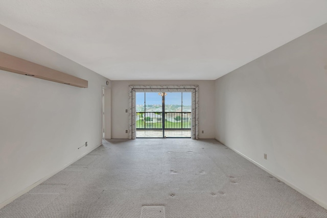 empty room with light carpet and baseboards