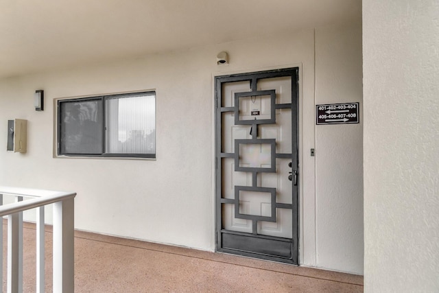 doorway to property with stucco siding