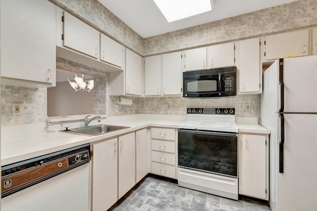 kitchen featuring white appliances, a sink, light countertops, decorative backsplash, and stone finish flooring