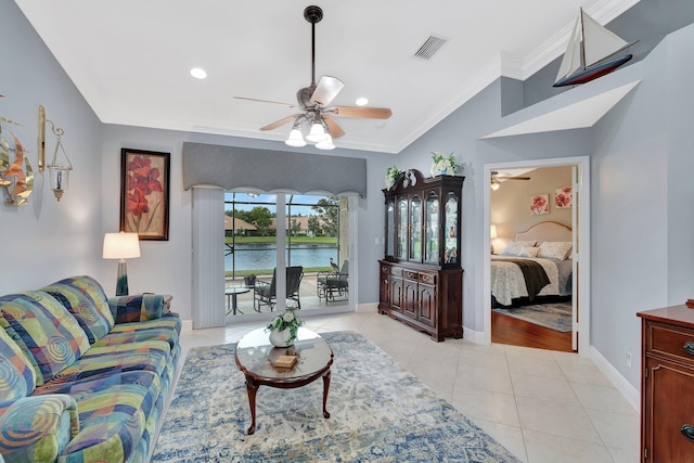 living room featuring light tile patterned floors, ornamental molding, ceiling fan, and a water view