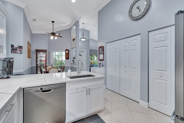 kitchen featuring sink, white cabinetry, light stone counters, stainless steel dishwasher, and ceiling fan