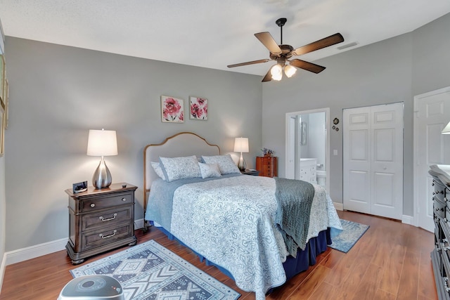 bedroom featuring ceiling fan, ensuite bathroom, and wood-type flooring