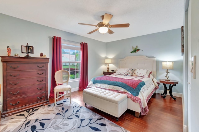 bedroom with wood-type flooring and ceiling fan