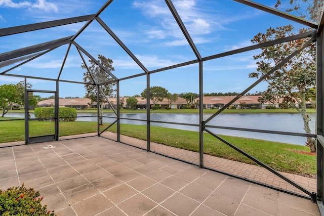 unfurnished sunroom with a water view