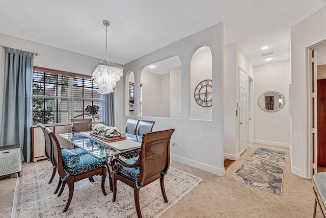 dining room featuring a chandelier, visible vents, and baseboards