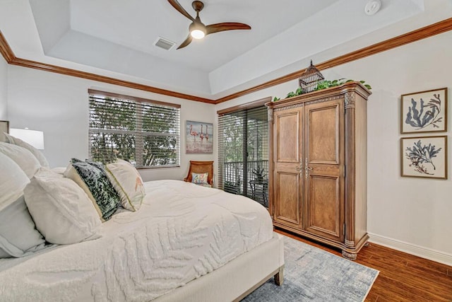 bedroom featuring baseboards, visible vents, a raised ceiling, dark wood-type flooring, and access to exterior