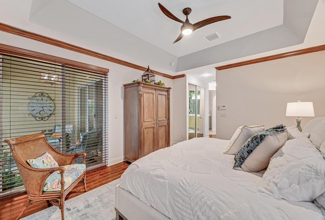 bedroom featuring light wood finished floors, visible vents, ceiling fan, access to outside, and crown molding