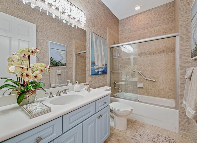 full bathroom featuring shower / bath combination with glass door, vanity, toilet, and tile patterned floors