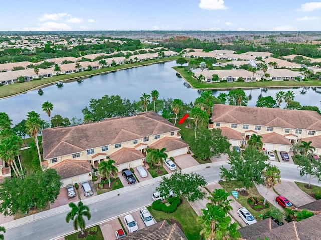 birds eye view of property featuring a water view and a residential view