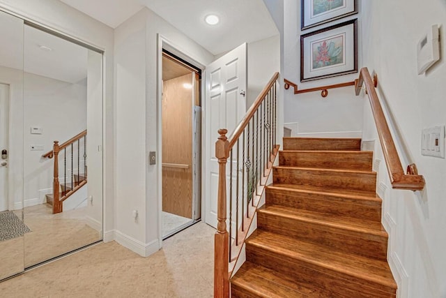 stairs with baseboards and recessed lighting