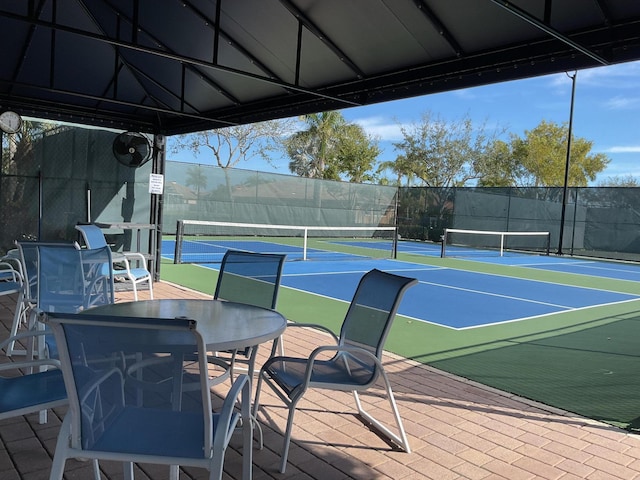 view of tennis court featuring fence