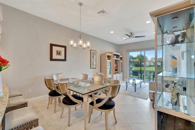 dining area with light tile patterned flooring and ceiling fan with notable chandelier