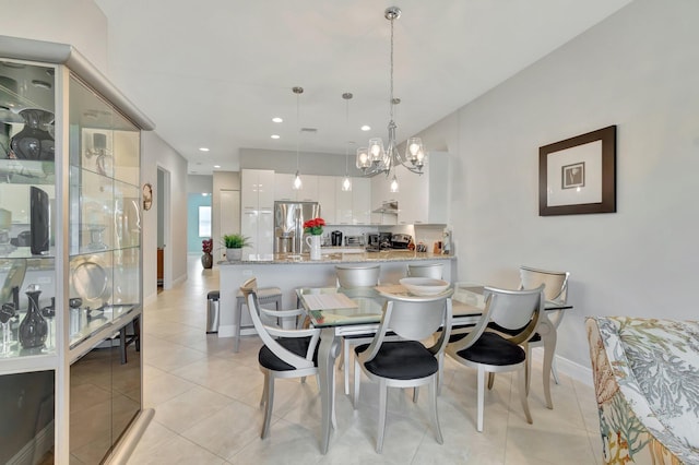 dining room with light tile patterned flooring and a chandelier